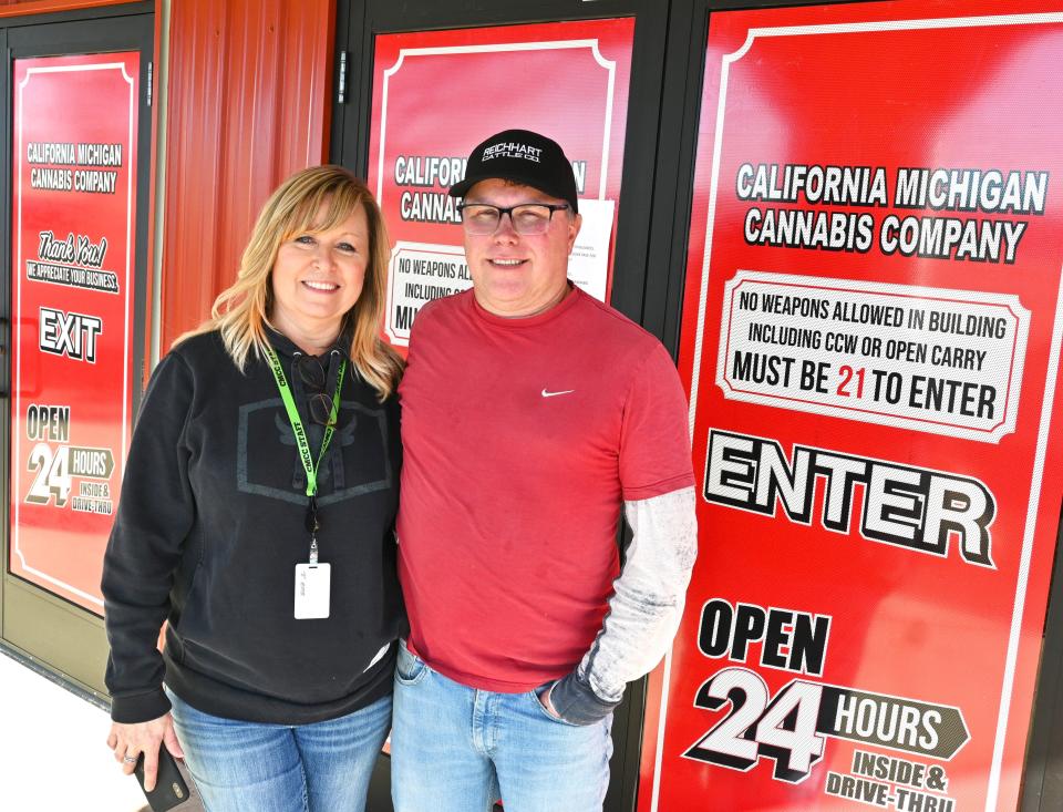 Terri and Jason Reichhart in front of their California Michigan Cannabis Company store on Fremont Road.