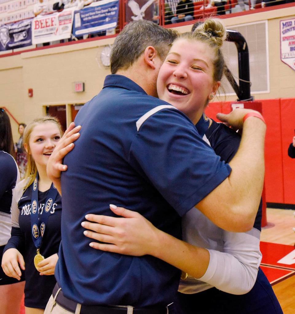 Philipsburg-Osceola’s Reese Hazelton hugs girls volleyball coach Dave Eckberg after receiving her gold medal Saturday after the Lady Mounties beat Trinity to claim the PIAA Class 2A state championship in Mechanicsburg at Cumberland Valley. P-O won 3-1.