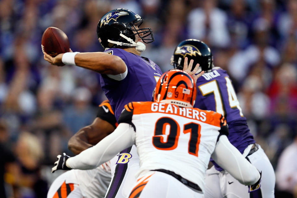 Quarterback Joe Flacco #5 of the Baltimore Ravens passes the ball in the first half as defensive end Robert Geathers #91 of the Cincinnati Bengals rushes in at M&T Bank Stadium on September 10, 2012 in Baltimore, Maryland. (Photo by Rob Carr/Getty Images)