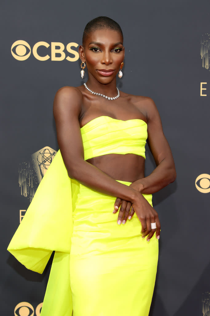 Michaela Coel made a statement in this canary yellow two-piece with oversized bow and stomach-bearing detailing. (Getty Images)