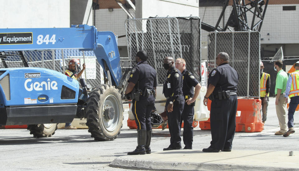 Emergency personnel respond to the parking garage that partially collapsed on Saturday, Sept. 12, 2020. The parking deck under construction has collapsed for a second time in as many days. Atlanta Fire Rescue said Saturday, that fire units were deployed to the building in the city's Midtown section for “a second major collapse” of the parking deck that partially fell Friday. (Steve Schaefer/Atlanta Journal-Constitution via AP)