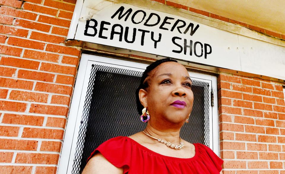 Carolyn Jones stands in front of Modern Beauty Shop.