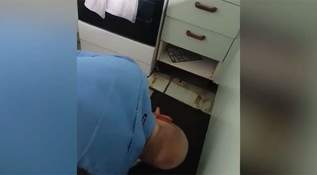 Mr McKenzie had to take out a board in the kitchen to retrieve the reptile. Source: Storyful