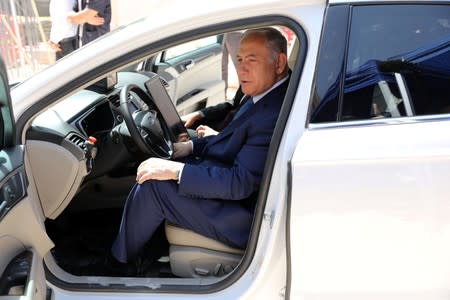 Israeli Prime Minister Benjamin Netanyahu sits inside an autonomous vehicle during a cornerstone-laying ceremony for Mobileye's center in Jerusalem