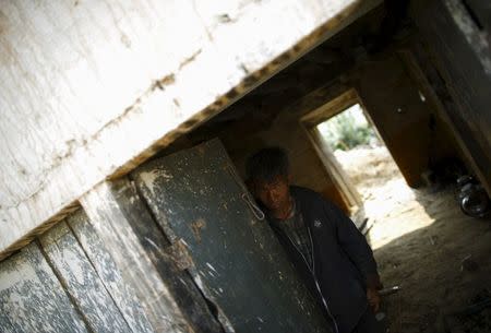 A man with cataract looks out from the door of his damaged house after the April 25 earthquake at a village on the outskirts of Lalitpur May 8, 2015. REUTERS/Navesh Chitrakar