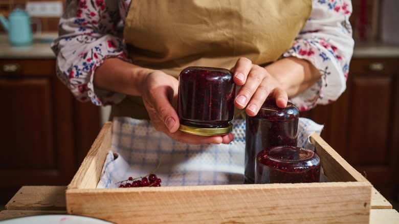 woman canning upside down jars