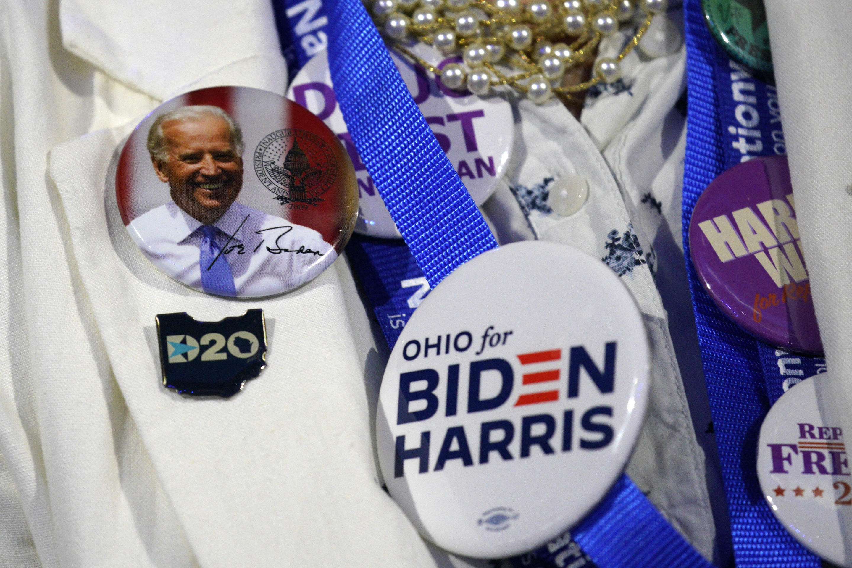 An attendee displays political pins inside the United Center in Chicago Monday. (Yuri Gripas/Abaca via ZUMA Press)