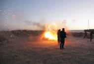 <p>Peshmerga fighters fire an from their position near the Altun Kubri checkpoint, 40kms from Kirkuk, on Oct. 20, 2017. Iraqi forces clashed with Kurdish fighters as the central government said it wrestled back control of the last area of disputed Kirkuk province in the latest stage of a lightning operation following a controversial independence vote. (Photo: Marc-Antoine Pelaez/AFP/Getty Images) </p>