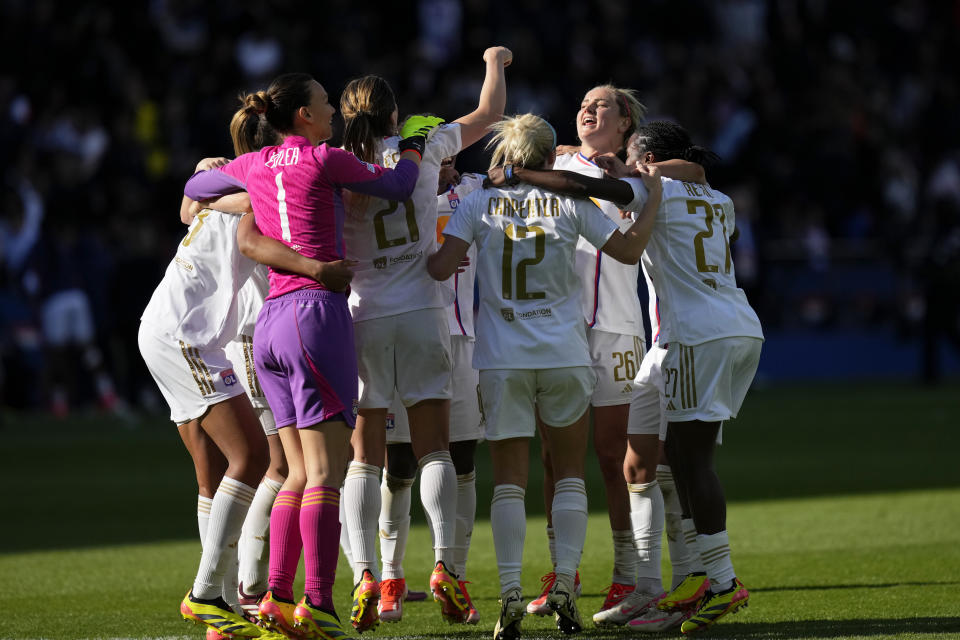 Lyon's Lindsey Horan, 2nd right, and her teammates celebrate at the end of the women's Champions League semifinal, second leg, soccer match between Paris Saint-Germain and Olympique Lyonnais at Parc des Princes, in Paris, Sunday, April 28, 2024. Lyon won 2-1 to advance to the final. (AP Photo/Thibault Camus)