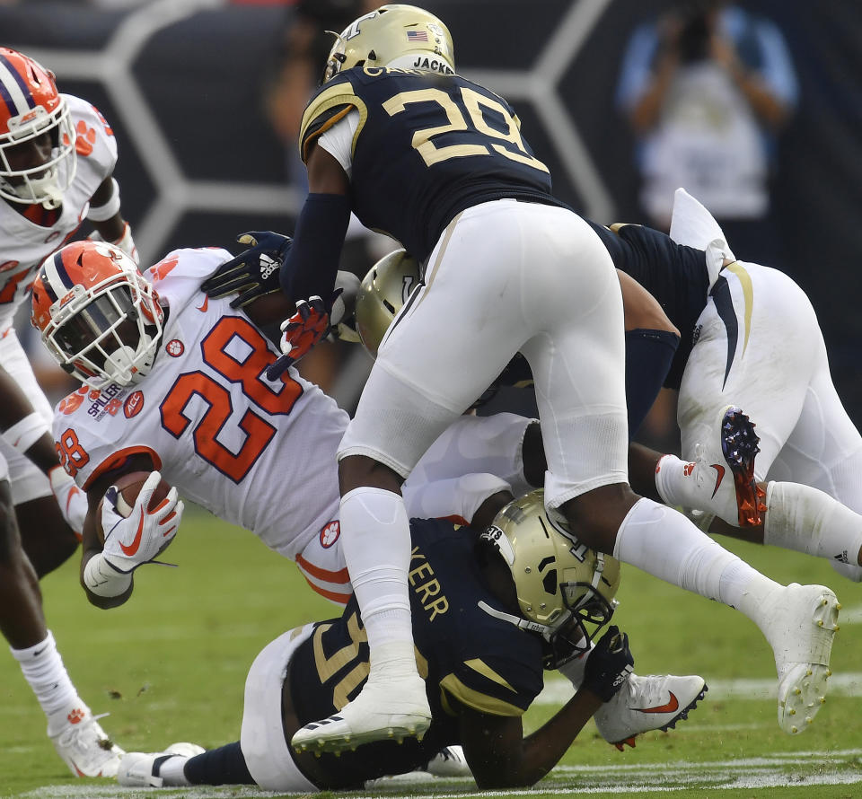 Clemson running back Tavien Feaster (28) is hit by Georgia Tech defensive back Tariq Carpenter (29) during the first half of an NCAA college football game, Saturday, Sept. 22, 2018, in Atlanta. (AP Photo/Mike Stewart)