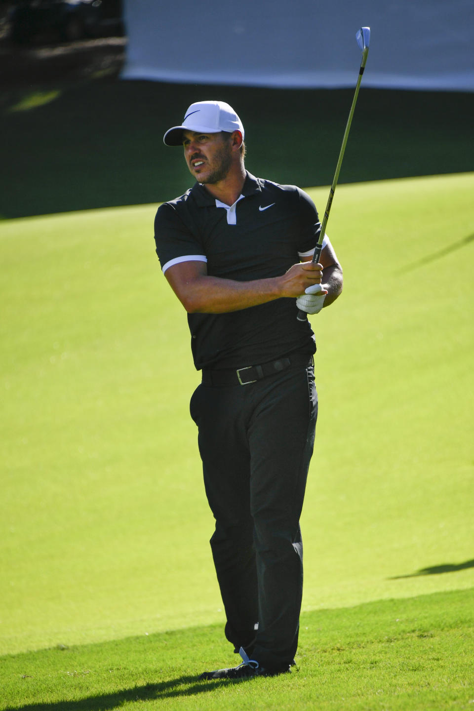 Brooks Koepka watches his shot to the 18th green during the first round of the Tour Championship golf tournament Thursday, Aug. 22, 2019, in Atlanta. Koepka ended the day tied for the lead with Xander Schauffele and Justin Thomas at 10 under par. (AP Photo/John Amis)