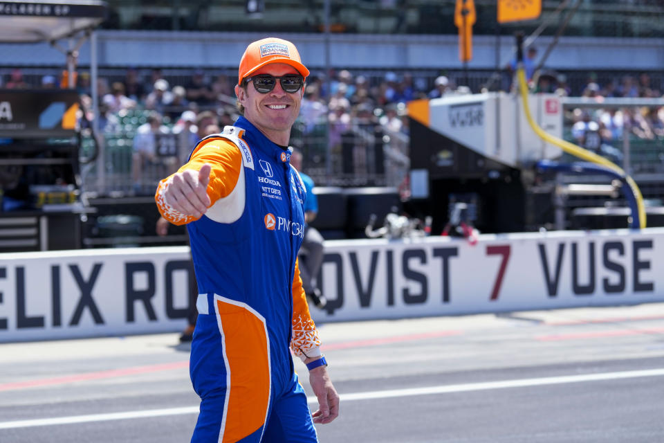 Scott Dixon, of New Zealand, walks to his car before the Indianapolis 500 auto race at Indianapolis Motor Speedway in Indianapolis, Sunday, May 29, 2022. (AP Photo/AJ Mast)