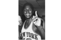 FILE - New York Knicks NBA basketball player Willis Reed celebrates in the dressing room after the Knicks beat the Los Angeles Lakers 113-99 to win the NBA championship in New York, May 8, 1970. Willis Reed, who dramatically emerged from the locker room minutes before Game 7 of the 1970 NBA Finals to spark the New York Knicks to their first championship and create one of sports’ most enduring examples of playing through pain, died Tuesday, March 21, 2023. He was 80. Reed's death was announced by the National Basketball Retired Players Association, which confirmed it through his family.(AP Photo/File)