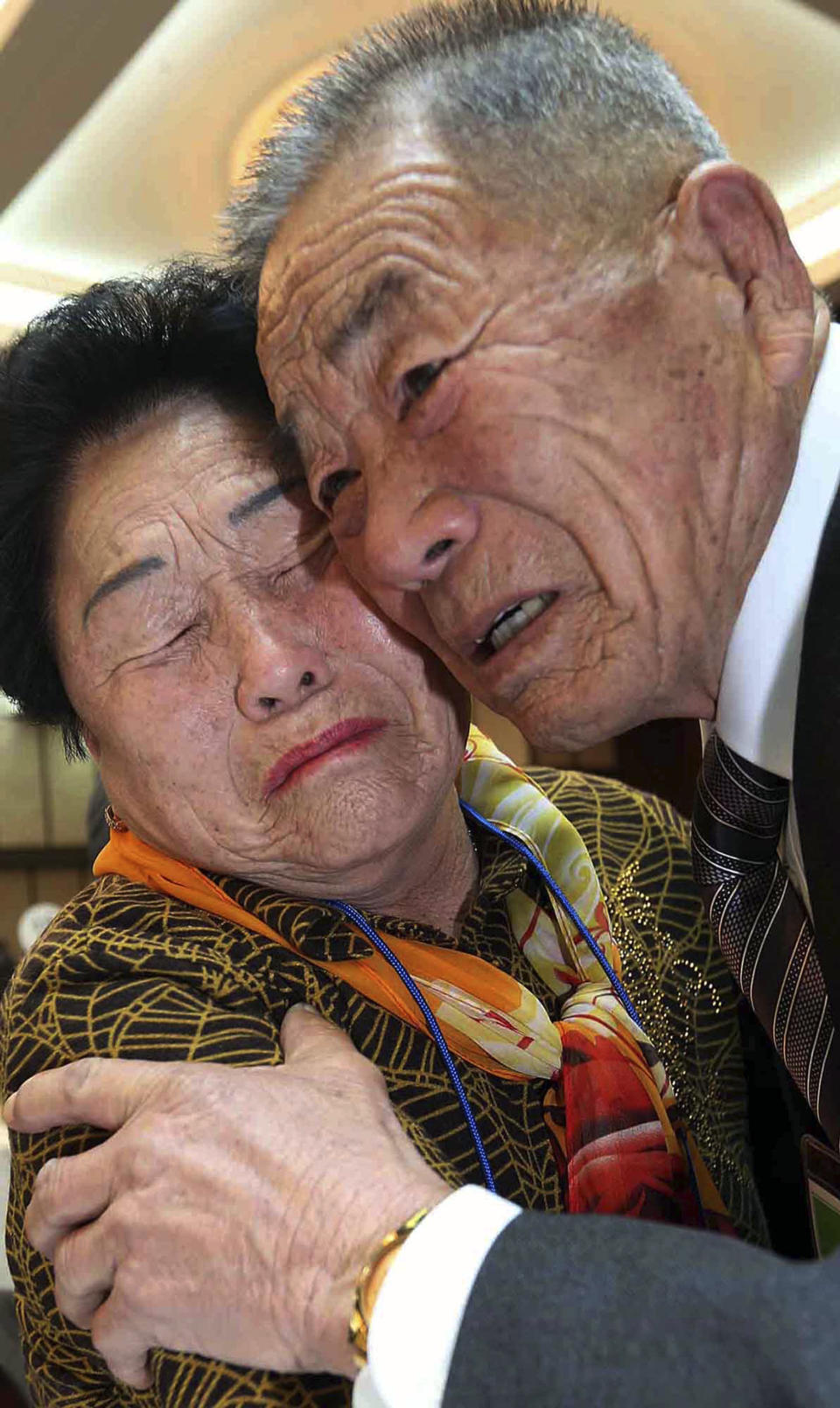 North Korean Lim Jong Soo, right, and his South Korean sister Lim Jong-suck get emotional as they reunite during the Separated Family Reunion Meeting at Diamond Mountain resort in North Korea, Sunday, Feb. 23, 2014. Elderly North and South Koreans separated for six decades are tearfully reuniting, grateful to embrace children, brothers, sisters and spouses they had thought they might never see again. (AP Photo/Yonhap, Lee Ji-eun) KOREA OUT