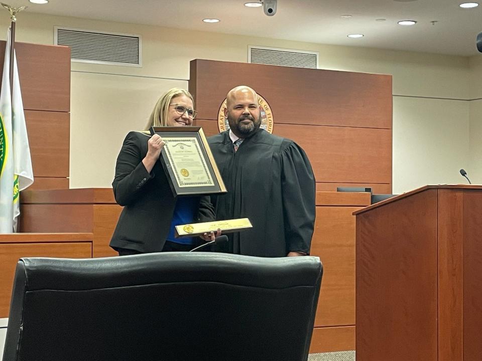 County Judge Charles Helm of Citrus County gives County Judge Lori Cotton her name plate and commission at Cotton's investiture on Friday afternoon at the Marion County Judicial Center.