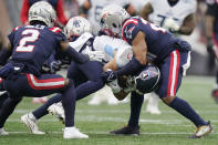 Tennessee Titans wide receiver Cody Hollister, center, is taken down by the New England Patriots during the first half of an NFL football game, Sunday, Nov. 28, 2021, in Foxborough, Mass. (AP Photo/Steven Senne)