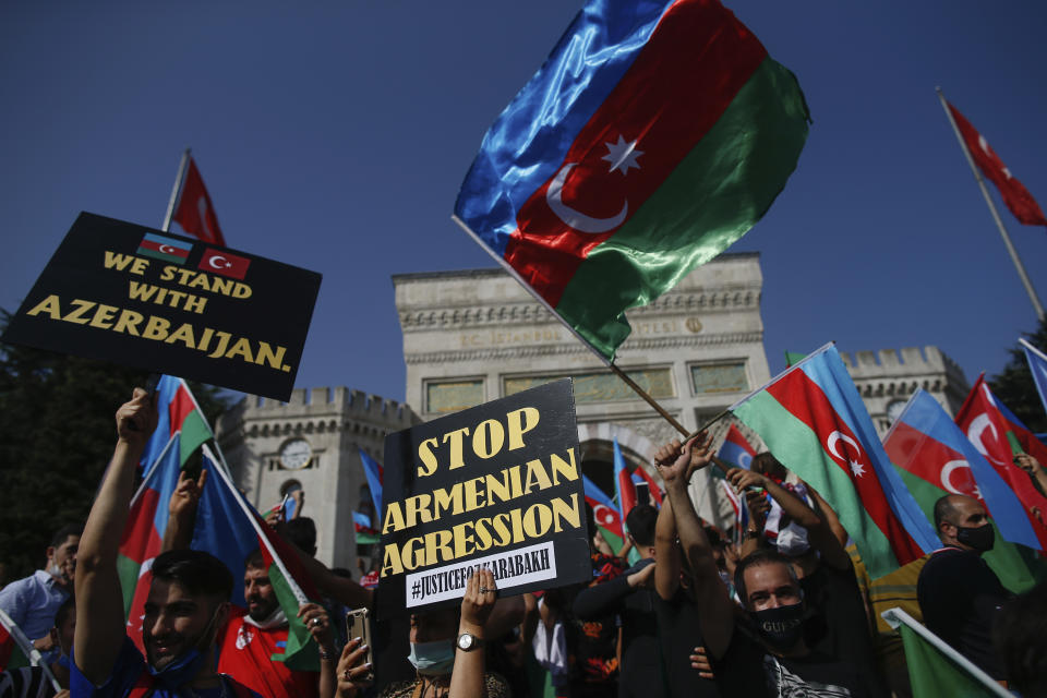 Demonstrators, holding Turkish and Azerbaijani flags, chant slogans during a protest supporting Azerbaijan, in Istanbul, Sunday, Oct. 4, 2020. Armenian and Azerbaijani forces continue their fighting over the separatist region of Nagorno-Karabakh, following the reigniting of a decades-old conflict. Turkey, which strongly backs Azerbaijan, has condemned an attack on Azerbaijan's second largest city Gence and said the attack was proof of Armenia's disregard for law. (AP Photo/Emrah Gurel)