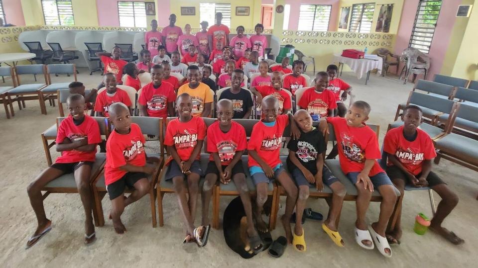 Residents of the Black and White for Jesus Ministries orphanage in Haiti pose for a photo in the church building that also serves as a school.