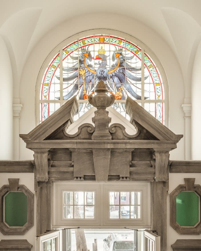 Original stained glass artwork from the prison remains on display in the converted Wilmina Hotel. 