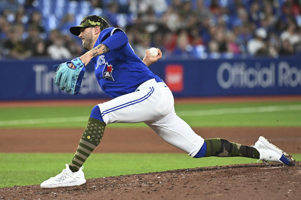 Toronto Blue Jays' Adam Cimber pitches against the Cincinnati Reds during the seventh inning of a baseball game Friday, May 20, 2022, in Toronto. (Jon Blacker/The Canadian Press via AP)