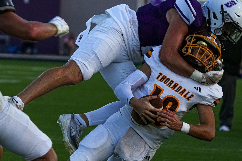 Thorndale quarterback Gunner Ferguson is tackled by Thrall defensive back Anson Gonzales during Thrall's season-opening win on Aug. 30.