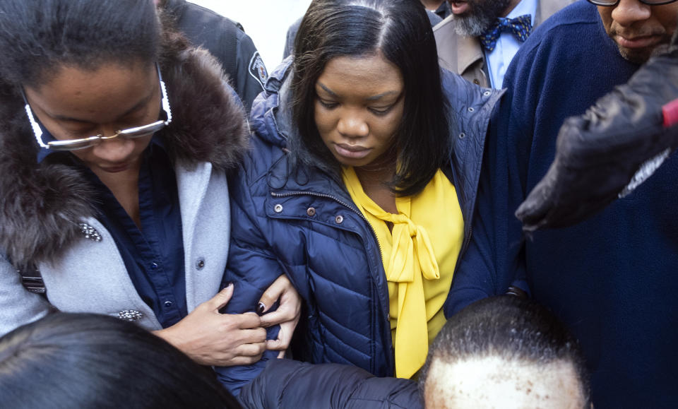 FILE - In this Nov. 25, 2019, file photo Tova Noel, center in yellow blouse, a federal jail guard responsible for monitoring Jeffrey Epstein the night he killed himself, leaves federal court in New York. The two Bureau of Prisons workers tasked with guarding Epstein the night he killed himself, Noel and Michael Thomas, have admitted they falsified records but will skirt any time behind bars under a deal with federal prosecutors, authorities said Friday, May 21, 2021. (AP Photo/Craig Ruttle, File)