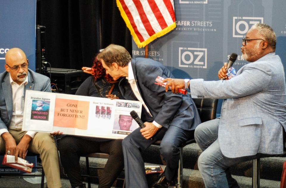 Mehmet Oz, MD, consoles a victim of gun violence during a closed-door community discussion on gun violence and public safety in the Germantown section of Philadelphia, PA, on September 19, 2022. Senate Candidate Mehmet Oz Hold Closed Door Discussion On Gun Violence In Philadelphia, United States - 19 Sep 2022