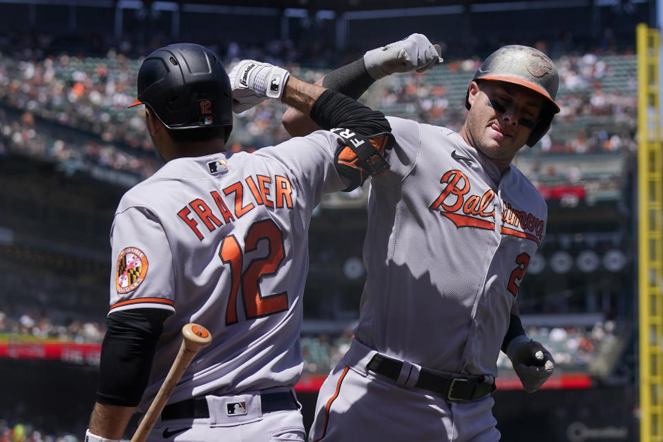 Baltimore Orioles' James McCann, right, is congratulated by Adam Frazier (12) after hitting a home run against the San Francisco Giants during the sixth inning of a baseball game in San Francisco, Sunday, June 4, 2023. (AP Photo/Jeff Chiu)