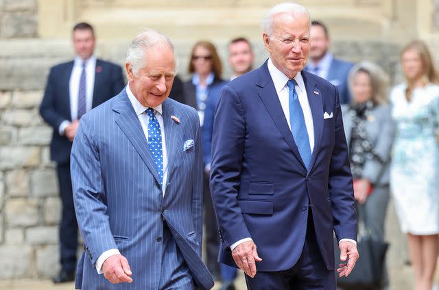 <p>Chris Jackson - WPA Pool/Getty Images</p> King Charles III and The President of the United States, Joe Biden walk together in the Quadrangle at Windsor Castle