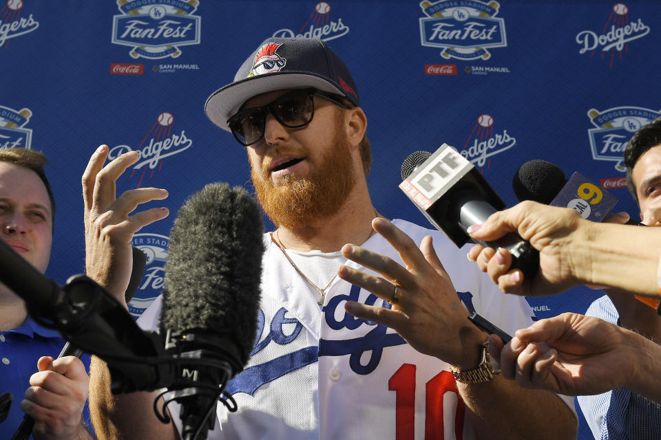 FILE - Los Angeles Dodgers' Justin Turner is interviewed by reporters during Dodger Stadium FanFest in Los Angeles, in this Saturday, Jan. 25, 2020, file photo. Justin Turner's extended flirtation with free agency ended where it began — with the Los Angeles Dodgers. Along the way, the third baseman had doubts about whether he would return to his hometown team and wondered if his mask-less appearance on the field to celebrate its World Series championship would hurt him. (AP Photo/Mark J. Terrill, File)
