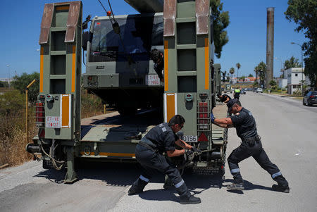 Members of the UME, a Spanish military emergency unit, unload a truck-mounted crane for the preparations of the new Center for Temporary Assistance to Foreigners (CATE) at the port of Algeciras in San Roque, southern Spain, July 30, 2018. REUTERS/Jon Nazca