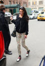 <p>A dressed down look with a black sweater, printed pants, a Balenciaga bag and patent leather shoes. <i>(Photo by Raymond Hall/GC Images)</i></p>