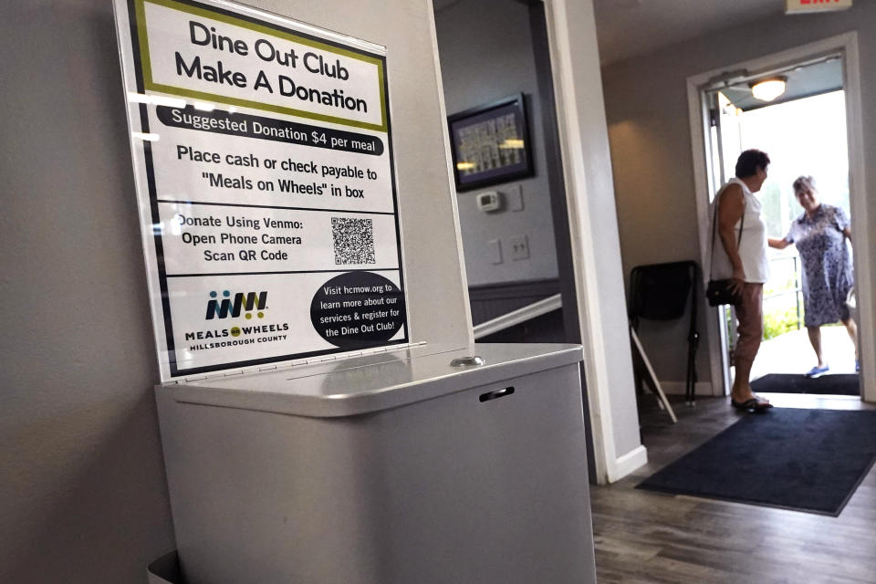 A donation box for the Meals on Wheels "Dine Out Club" is posted at the White Birch Cafe, Wednesday, Aug. 16, 2023, in Goffstown, N.H. Senior citizens order breakfast and lunch off a special menu, which meets the nutrition guidelines by the USDA for adults under the federal Older Americans Act Nutrition Program. (AP Photo/Charles Krupa)