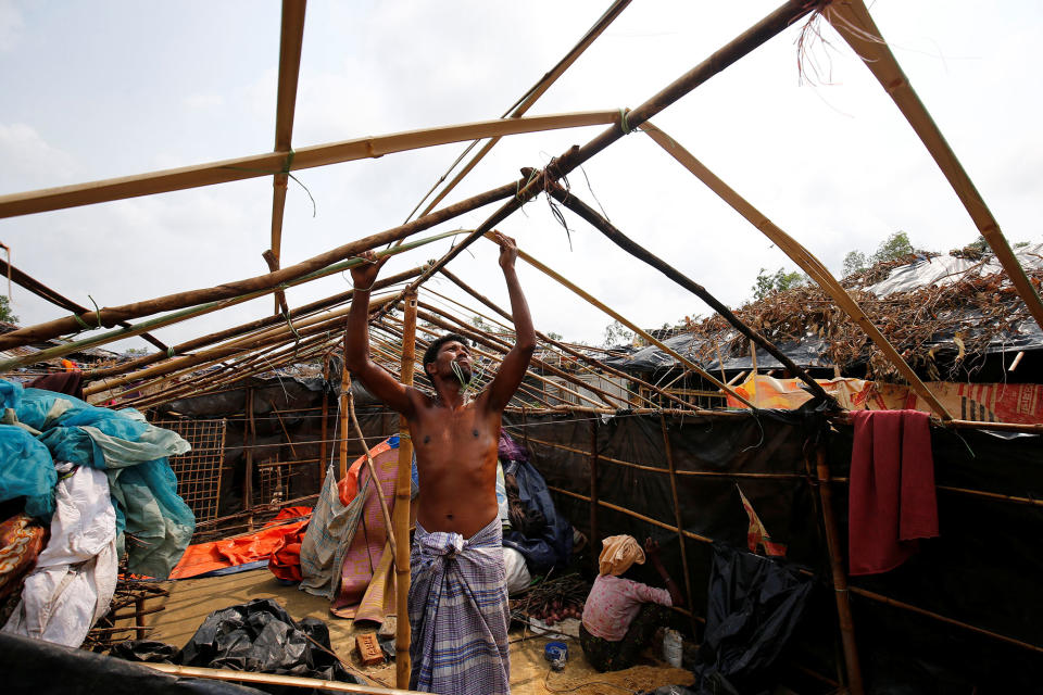 A Rohingya refugee rebuilds his makeshift house