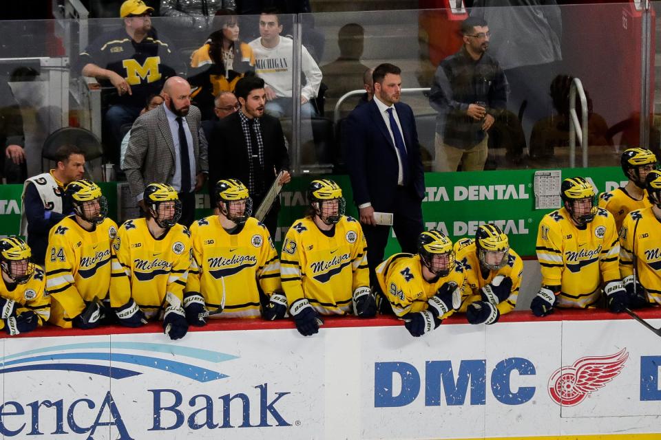 Michigan interim head coach Brandon Naurato, center, watches a play against Michigan State during overtime of the "Duel in the D" at Little Caesars Arena in Detroit on Saturday, Feb. 11, 2023.