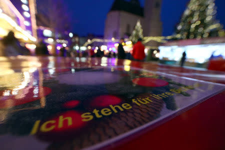 A sign reading "I stand here for your security" is seen on concrete barricades at the entrance of the Christmas market in Regensburg, Germany, November 27, 2017. REUTERS/Michael Dalder