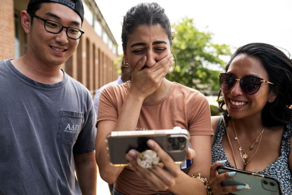 Fans wait outside the Fairfax County Courthouse as they watch a livestream of the Depp vs. Heard case verdict