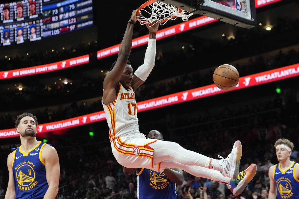 Atlanta Hawks forward Onyeka Okongwu (17) scores against the Golden State Warriors in overtime in an NBA basketball game Saturday, Feb. 3, 2024, in Atlanta. (AP Photo/John Bazemore)