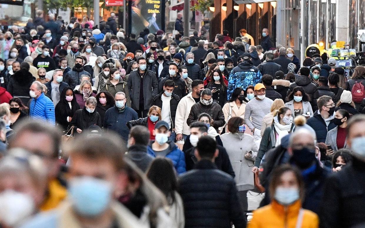 People wearing mandatory face masks in a shopping street in Dortmund, Germany - Martin Meissner /AP