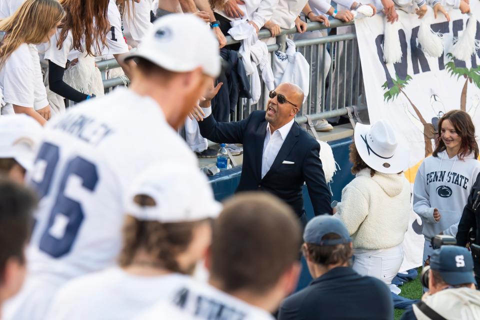 Penn State football head coach James Franklin high-fives members of the student section as he walk around Beaver Stadium before facing Minnesota in a White Out game on Saturday, Oct. 22, 2022, in State College.
