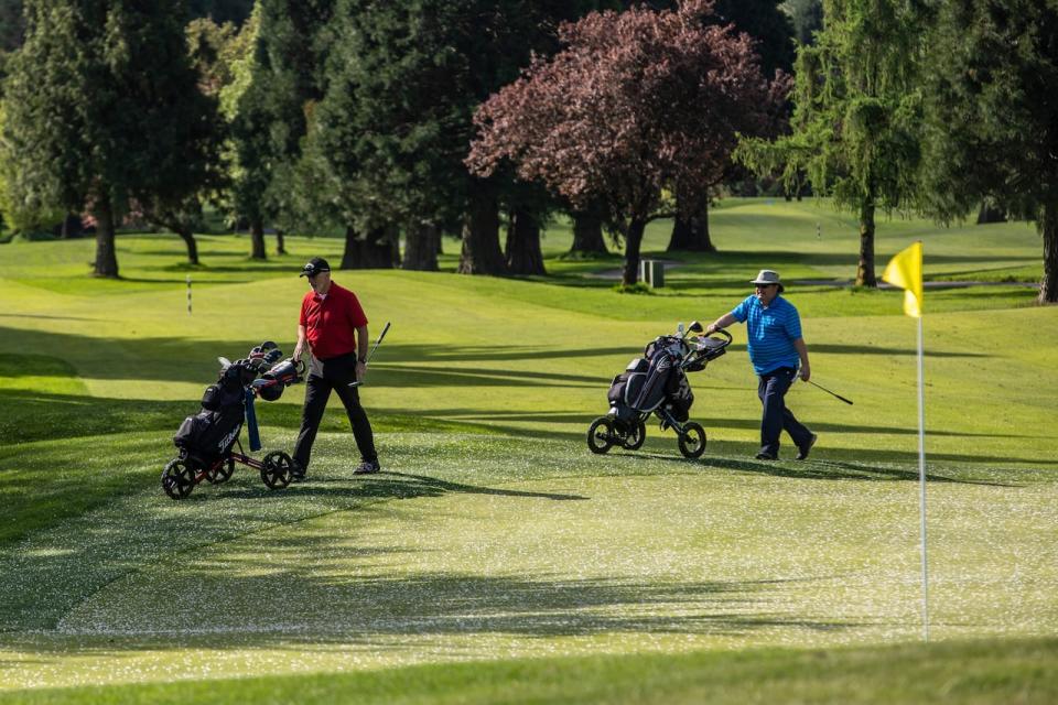 Golfers are pictured at the reopening of the McCleery Golf Club in Vancouver, British Columbia on Friday, May 1, 2020. 