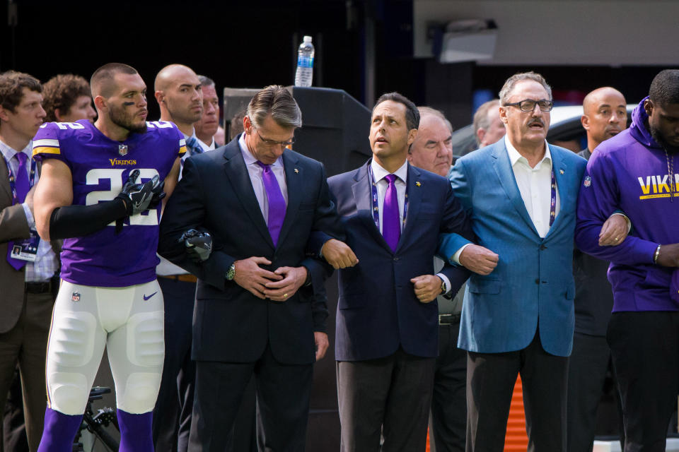 <p>Minnesota Vikings defensive back Harrison Smith (22) locks arms with general manager Rick Spielman (left) and owner Mark Wilf (middle) and owner Ziggy Wilf (right) before the game against the Tampa Bay Buccaneers at U.S. Bank Stadium. Mandatory Credit: Brad Rempel-USA TODAY Sports </p>