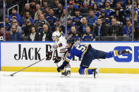 Chicago Blackhawks' Patrick Kane (88) handles the puck in front of St. Louis Blues' Colton Parayko (55) during the first period of an NHL hockey game Tuesday Feb. 25, 2020, in St. Louis. (AP Photo/Scott Kane)