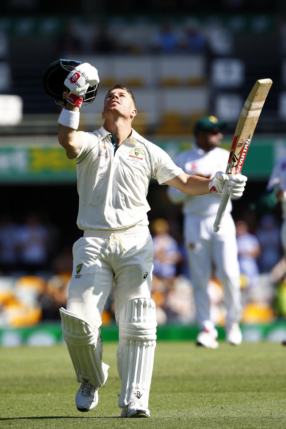Australia's David Warner celebrates after scoring 100 runs during their cricket test match against Pakistan in Brisbane, Australia, Friday, Nov. 22, 2019. (AP Photo/Tertius Pickard)