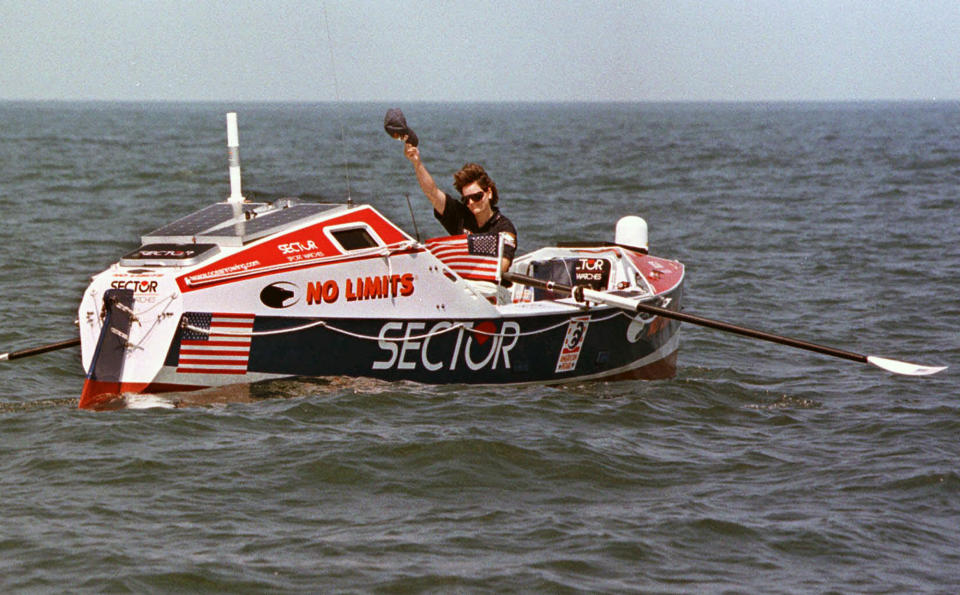 FILE - Rower Tori Murden, of Louisville, Ky., waves from her boat off North Carolina's Outer Banks, near Nags Head, N.C. , on June 14, 1998. A musical about Murden, who was the first American to row across the Atlantic Ocean solo in 1999, was supposed to make its stage debut at the Williamstown Theatre Festival in Massachusetts in the summer 2020. But due to the global pandemic, it is instead making its world premiere this month as a recording available on Audible. (AP Photo/Bob Jordan, File)