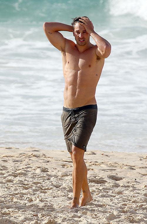 His defined biceps and ripped torso were on full display as he took a dip in the ocean.