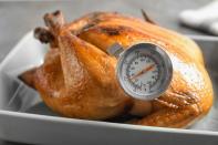 <p>Though there are rough estimates for how long it takes a turkey to roast, the only guaranteed way you will know your dinner is done is when it reaches a minimum internal temperature of 165 degrees. Use a meat thermometer and take the temperature in the thickest part of the breast, thigh and stuffing (if you stuffed your bird). No matter what you do, <a href="https://www.thedailymeal.com/cook/are-turkey-pop-up-timers-accurate?referrer=yahoo&category=beauty_food&include_utm=1&utm_medium=referral&utm_source=yahoo&utm_campaign=feed" rel="nofollow noopener" target="_blank" data-ylk="slk:don’t rely simply on those plastic pop-up timers;elm:context_link;itc:0;sec:content-canvas" class="link ">don’t rely simply on those plastic pop-up timers</a> many turkeys come equipped with, or by the color of the skin. By the time they pop up, your turkey may be completely overcooked and dry. Additionally, your turkey’s skin may look golden brown long before it has reached a safe temperature.</p>