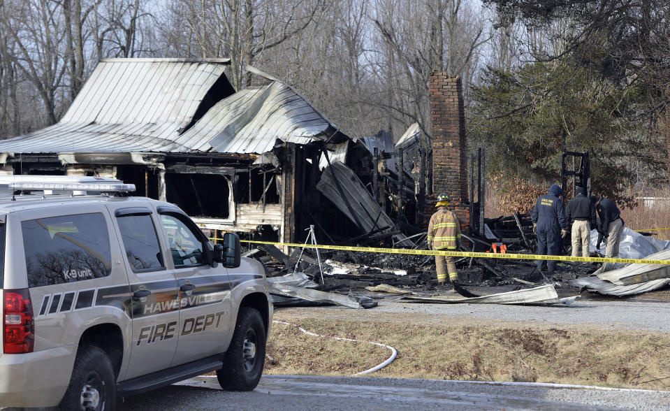 Members of the Kentucky State Fire Marshall's office look over the remains of a house fire in Depoy, Ky. Thursday Jan. 30, 2014. As many as nine people were killed early Thursday in a house fire in rural western Kentucky and two people were taken to a hospital for treatment, officials said. Eleven people lived in the home in the Depoy community of Muhlenberg County, Greenville Assistant Fire Chief Roger Chandler said. (AP Photo/Timothy D. Easley)