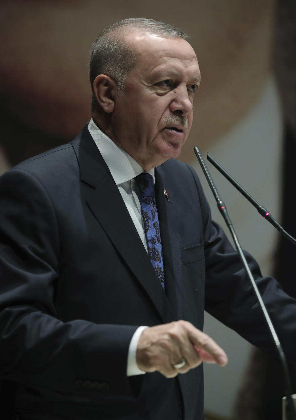 Turkey's President Recep Tayyip Erdogan addresses the members of his ruling party, in Ankara, Turkey, Thursday, Dec. 26, 2019. Erdogan says Thursday his government will submit a bill to parliament that would allow Turkey to send troops to Libya, in support of the U.N.-backed government there. Erdogan said the Libyan government, which controls the capital, Tripoli, has "invited" Turkey to send troops. (Turkish Presidency via AP, Pool)