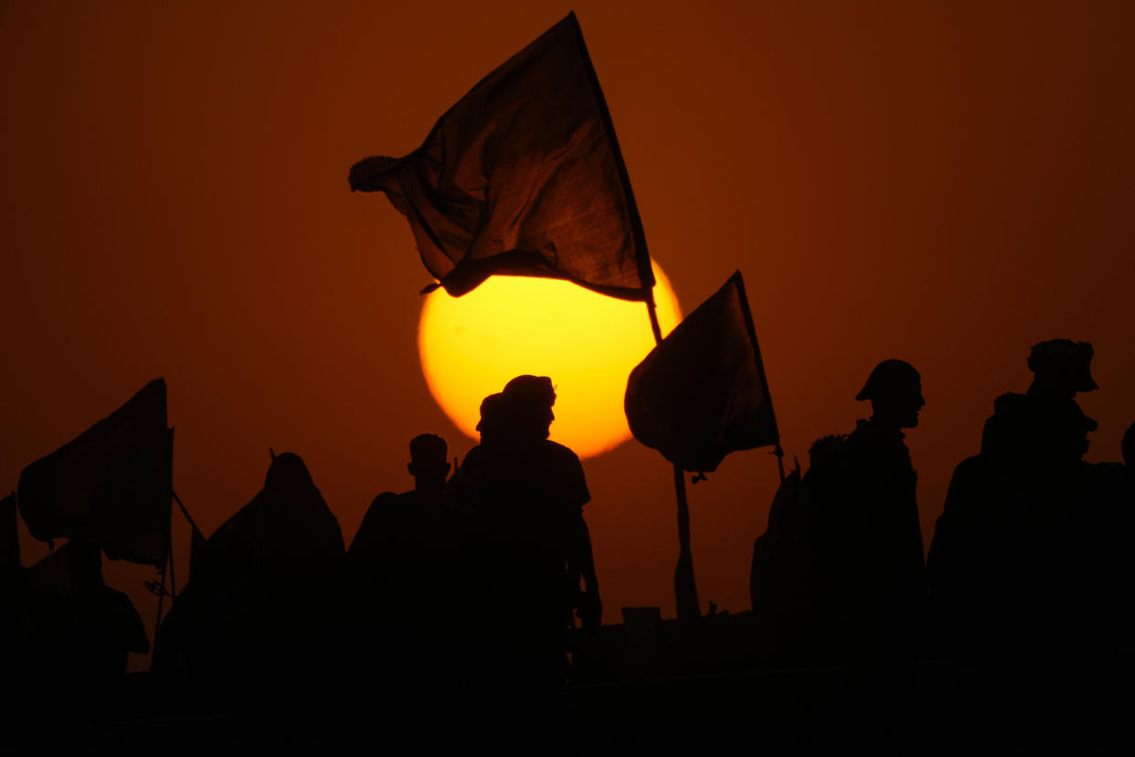 The supermoon can be seen rising as Shiite pilgrims make their way to Karbala, Iraq, for a big public ritual called Arbaeen.